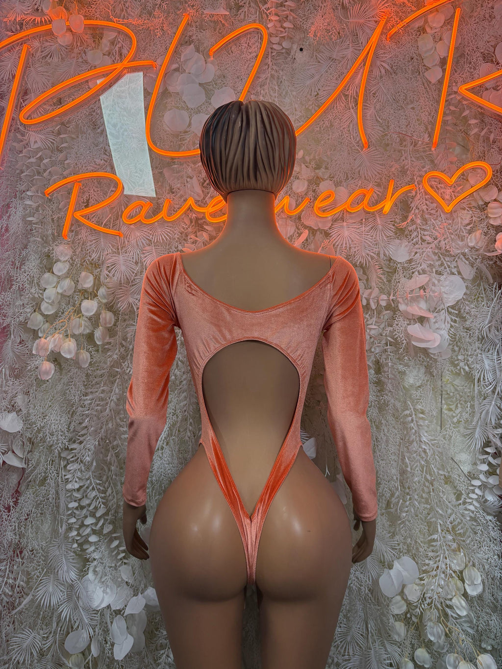 Orange velvet one-piece bodysuit, open-back thong style, long sleeves
