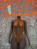 Orange metallic one-piece bodysuit with twisted halter front straps