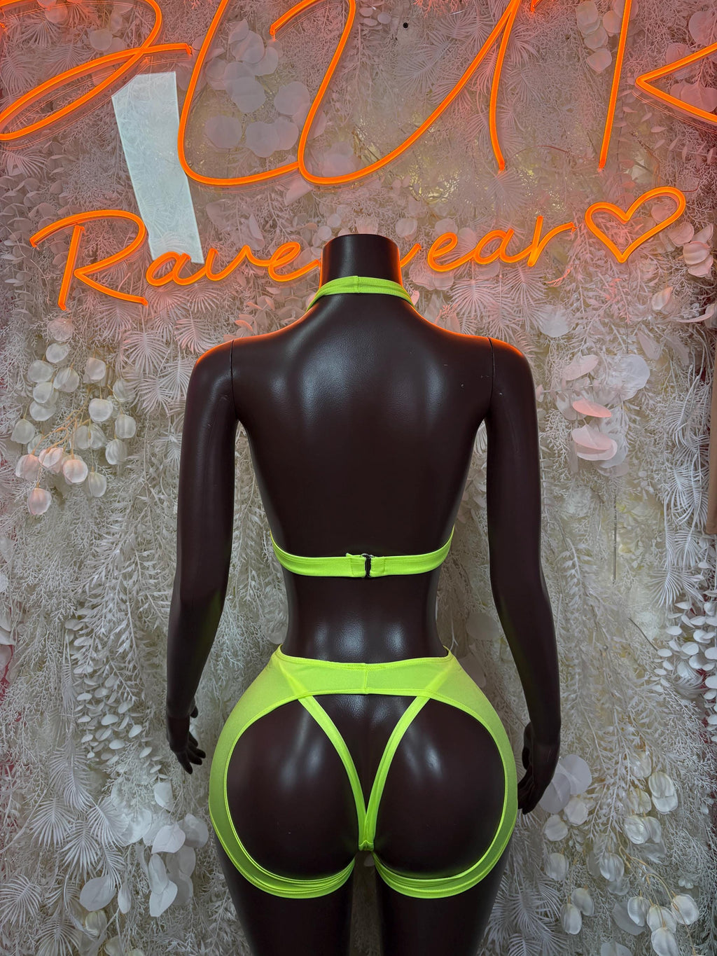Neon green ravewear set with high-cut thong bottoms, back view on mannequin