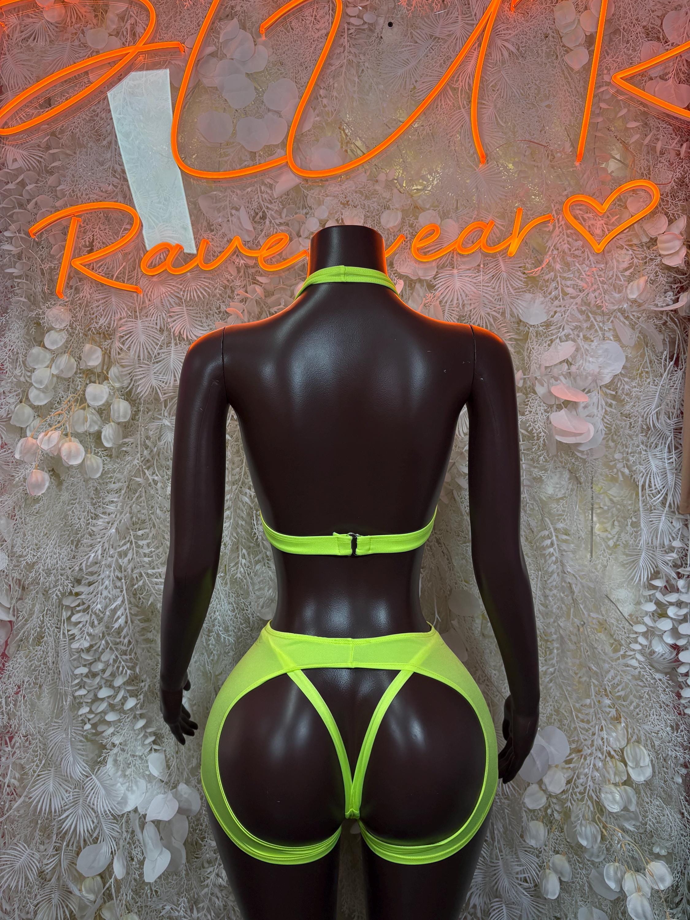 Neon green ravewear set with high-cut thong bottoms, back view on mannequin