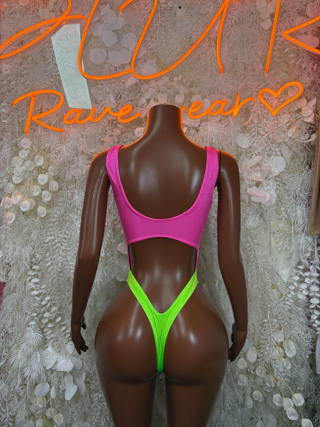 Pink scoop-neck bodysuit with green high-cut bottom panel, front view