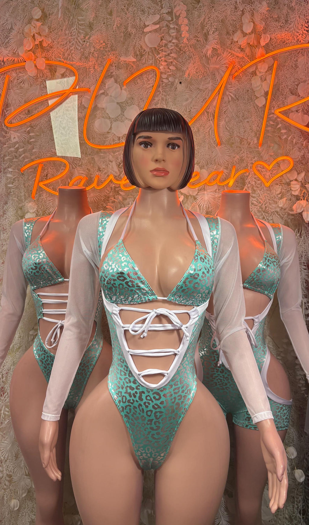 Teal cheetah bodysuit with deep V neckline and white lace-up chest, sheer sleeves