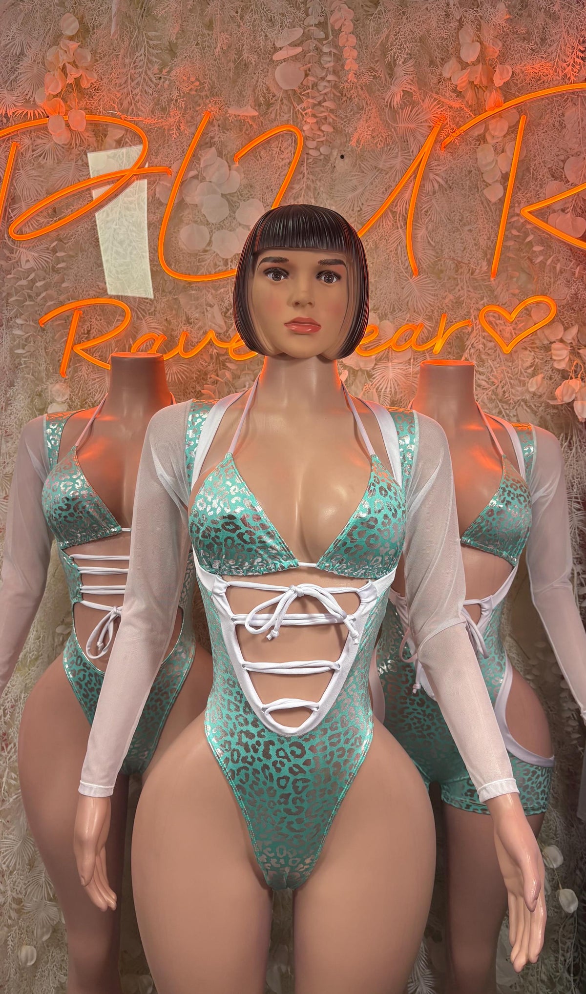 Teal cheetah bodysuit with deep V neckline and white lace-up chest, sheer sleeves