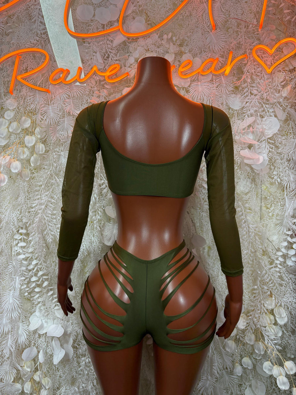 Green rave two-piece set from back: lace-up crop top with long sleeves, strappy shorts