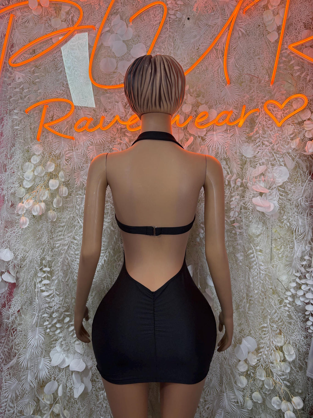 Black backless mini dress with cross straps and central waist cutout