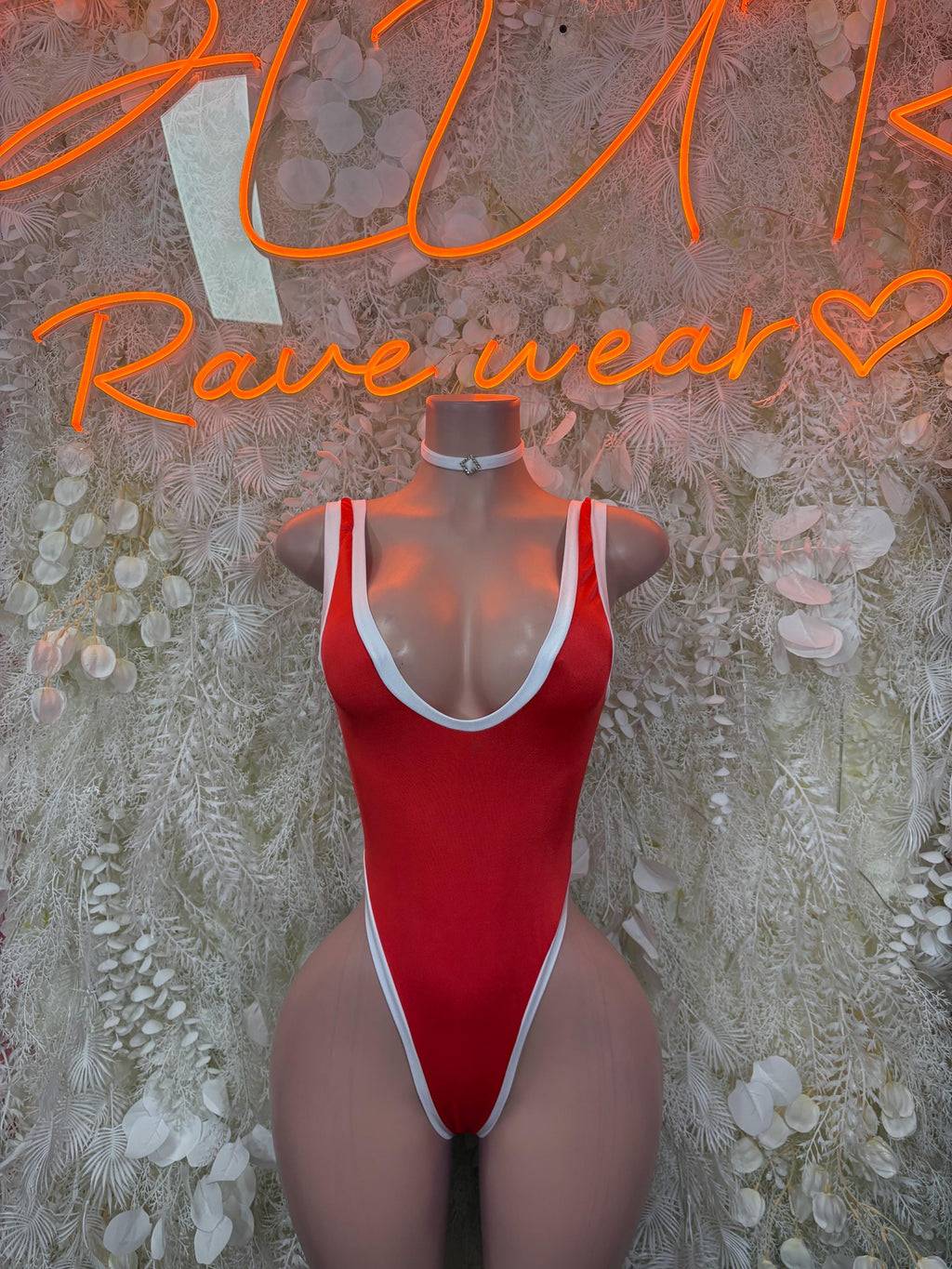 Red one-piece bodysuit with white trim and neck choker