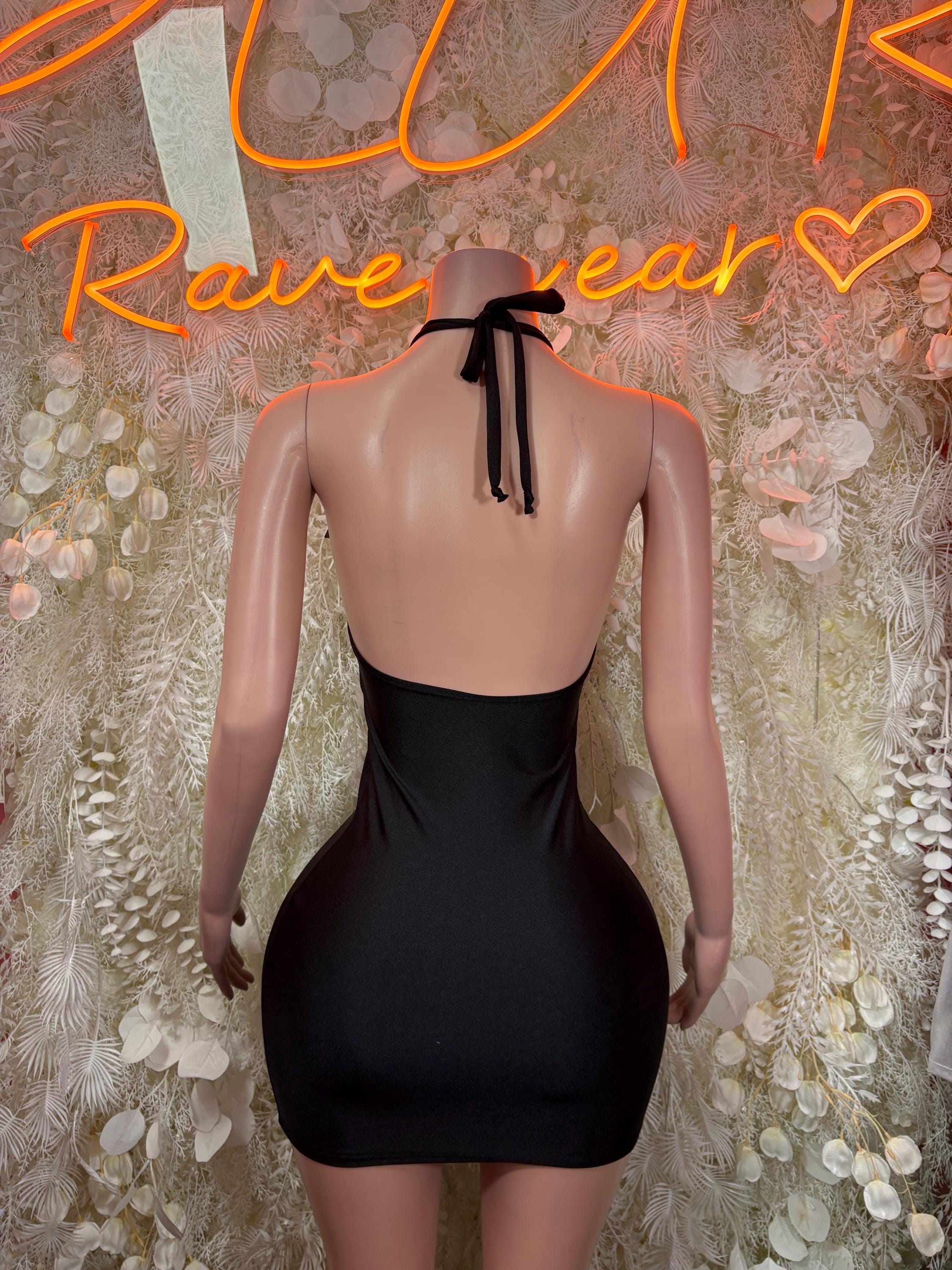 Black backless mini dress with halter tie-back and smooth fitted silhouette