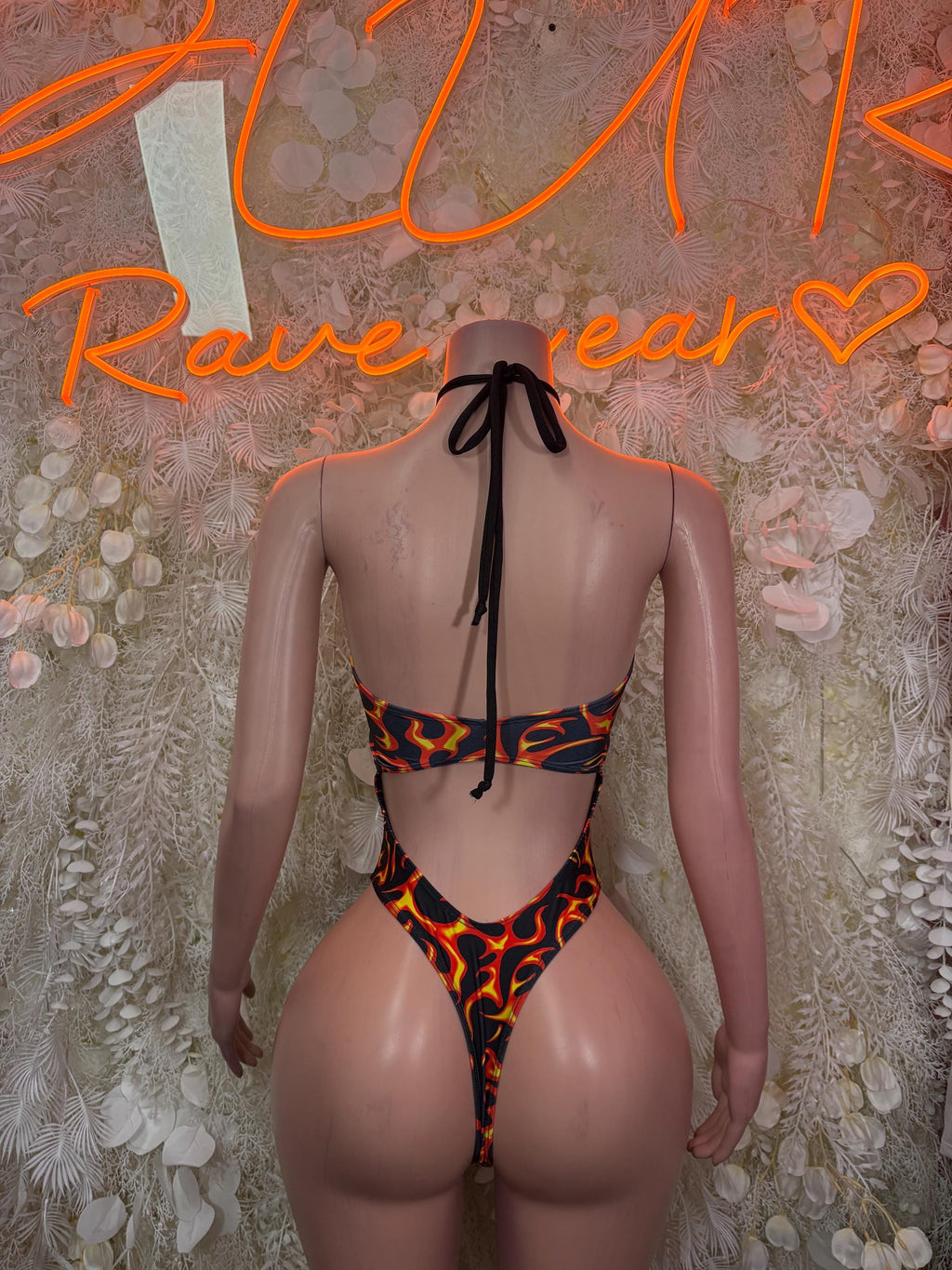 Flame-print bodysuit with crisscross black straps and low back tie