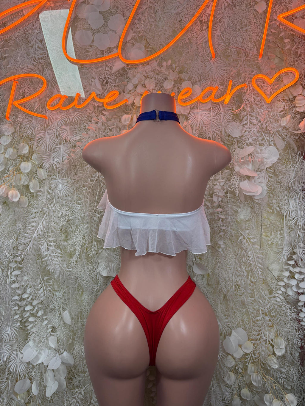 Back view of two-piece bikini with ruffled white halter top, red high-cut bottoms, blue choker