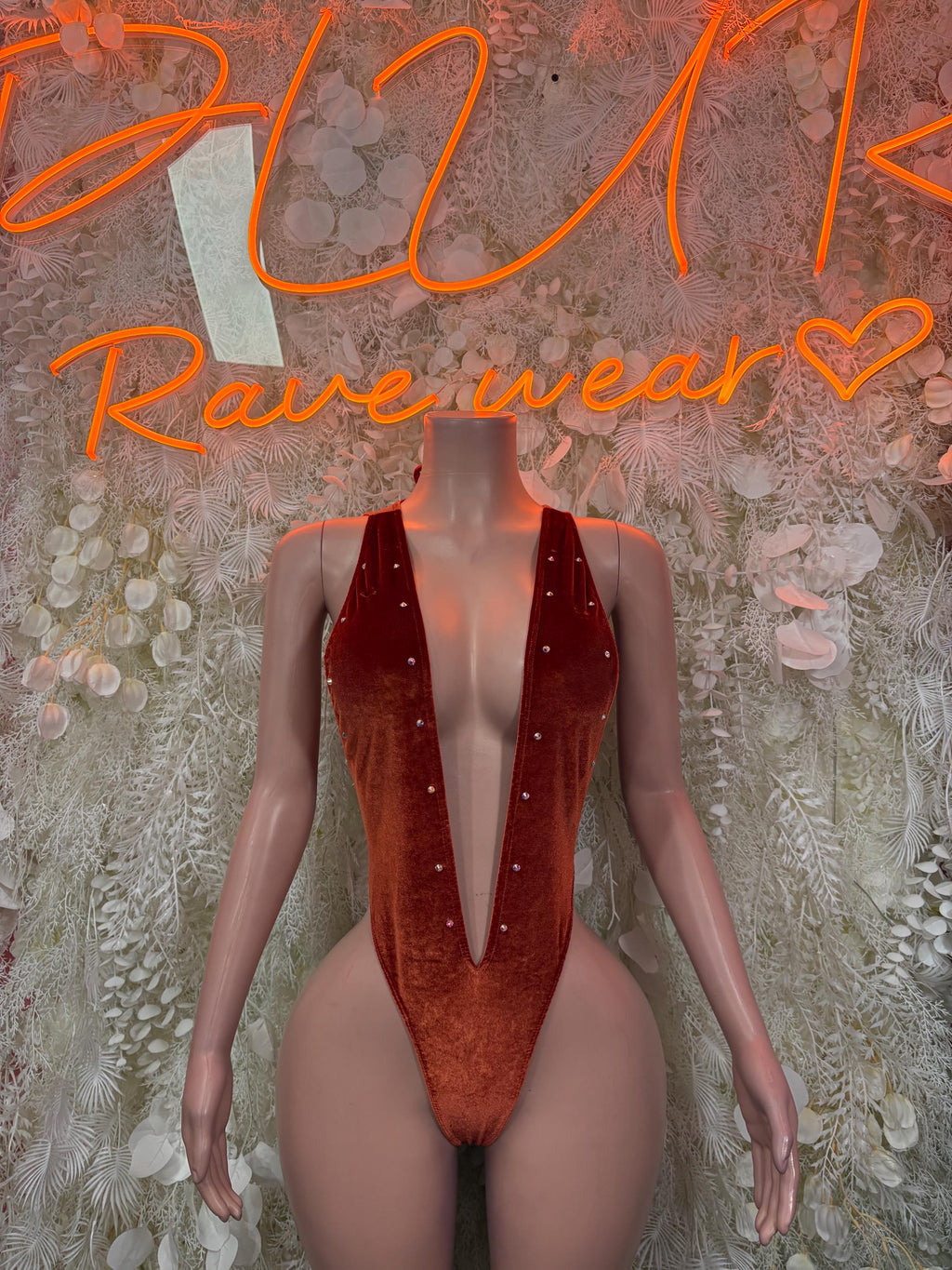 Velvet one-piece bodysuit, deep red with high-cut legs and plunging neckline.