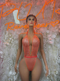 Orange fishnet one-piece bodysuit with halter straps and deep V neckline