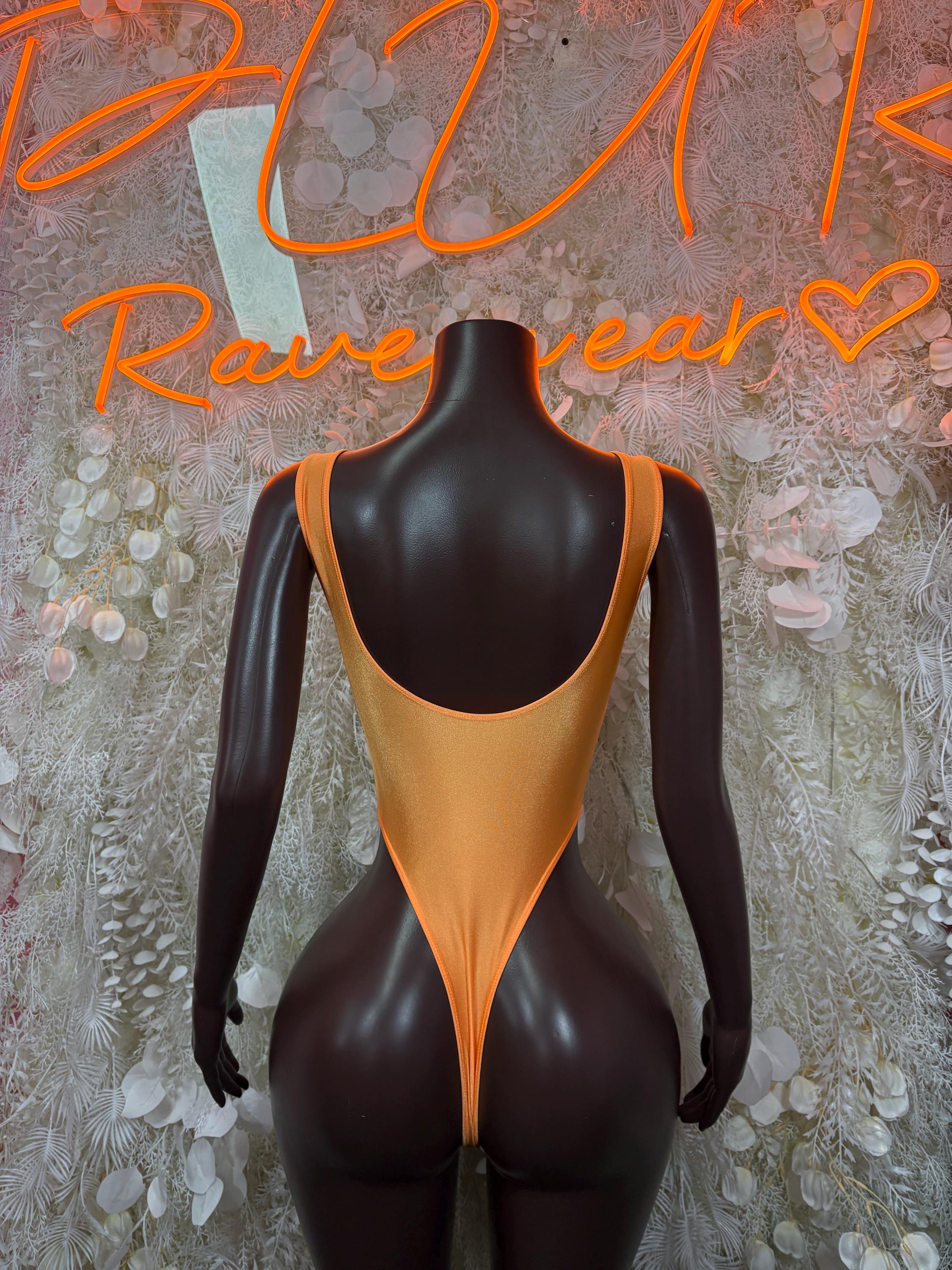 Orange one-piece bodysuit with scoop back and high-cut legs on mannequin