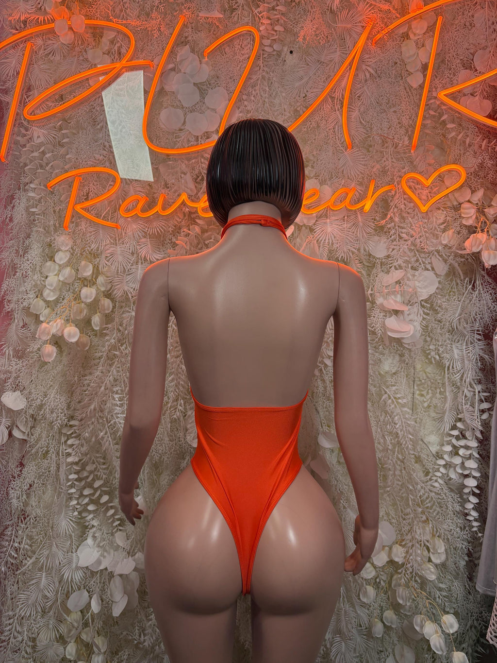 Orange halter one-piece bodysuit, back view with thin straps and open back