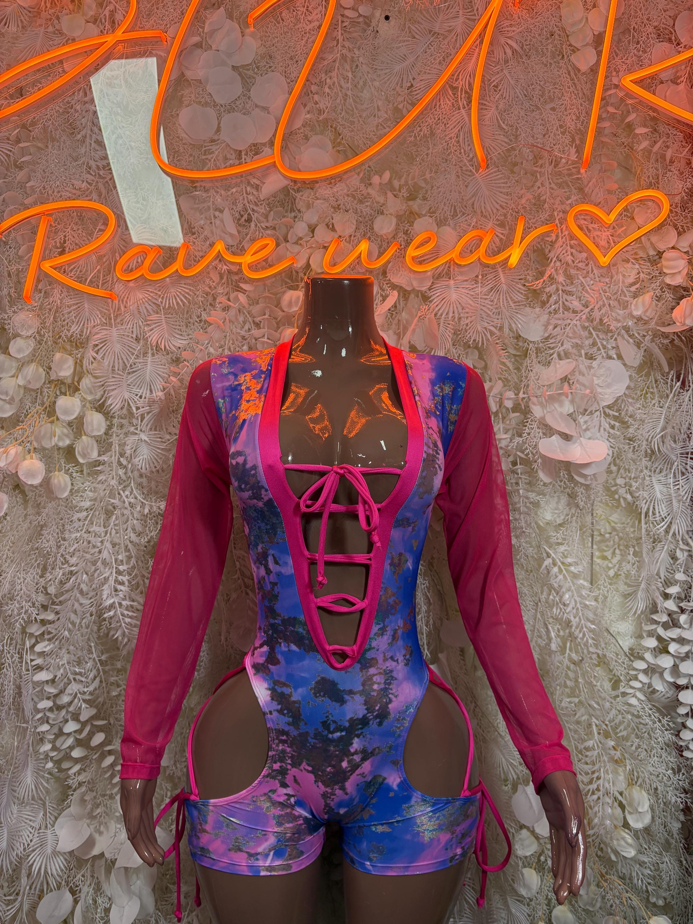 Pink and blue metallic bodysuit with lace-up front and long sleeves, cutout straps