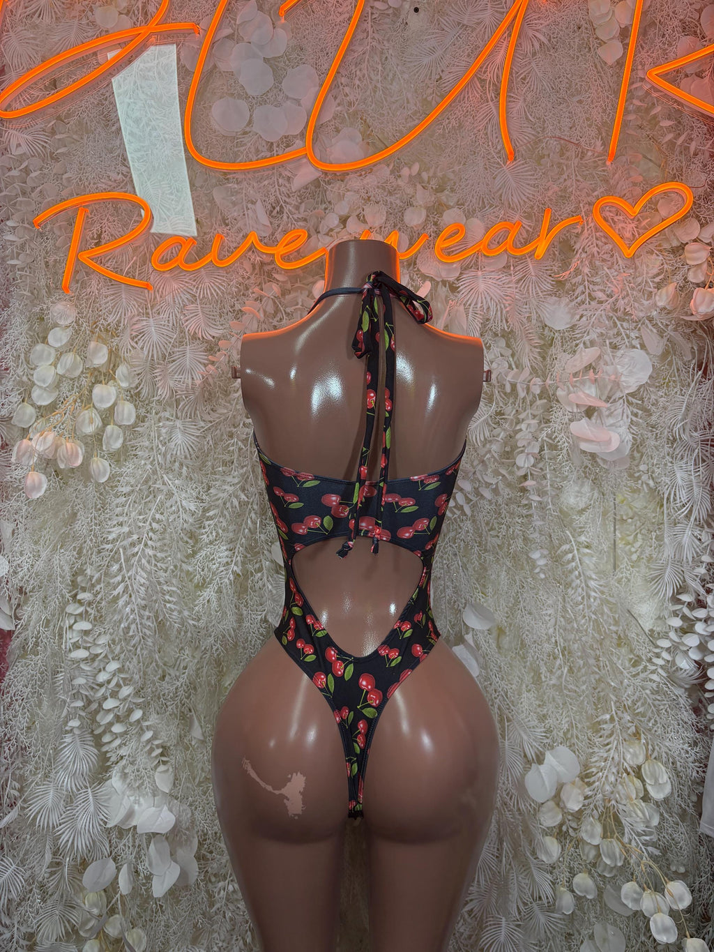 Cherry print one-piece bodysuit with open back and crisscross ties, black base