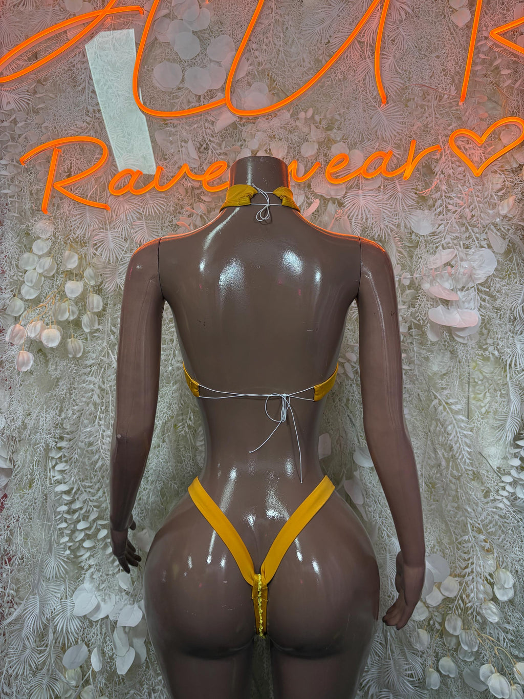 Yellow fishnet two-piece set with halter back and high-cut bottoms, orange trim