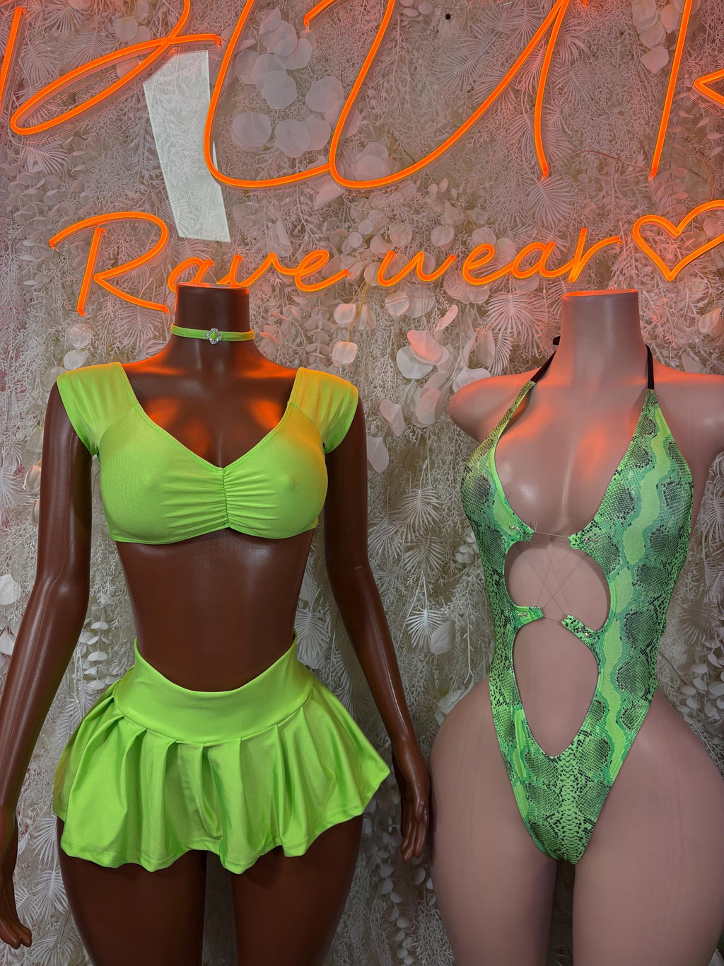 Neon green crop top and pleated mini skirt set with ruched front; green snakeskin swimsuit beside