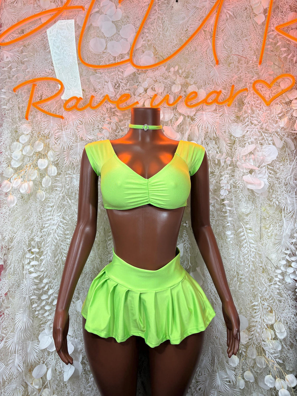 Neon green crop top with ruched bust and pleated mini skirt set, halter straps