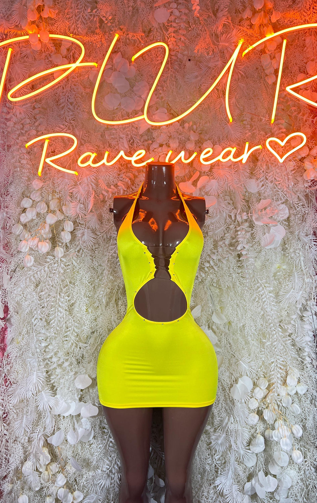 Neon yellow cutout mini dress with halter neckline and fitted bodycon silhouette