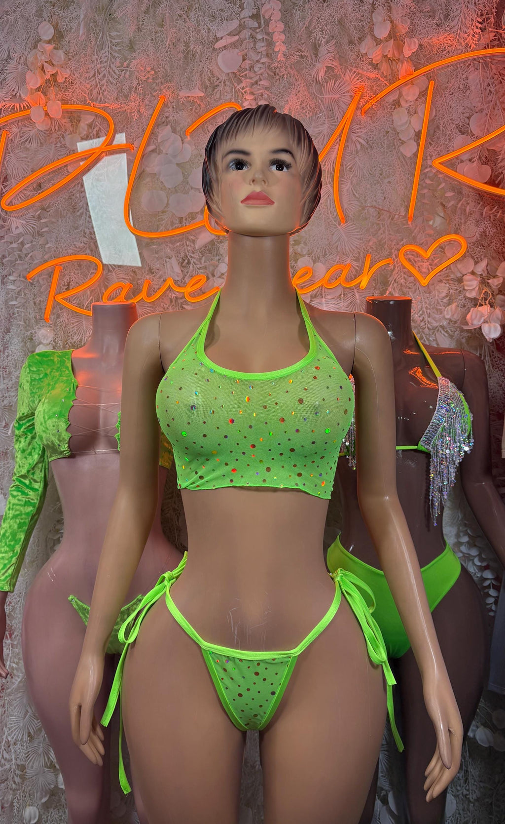 Green two-piece rave set with halter crop top and tie-string thong bikini bottoms