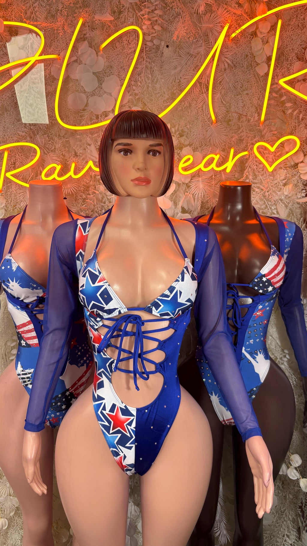 Patriotic blue star-print bodysuit with long sleeves and crisscross lace-up front.