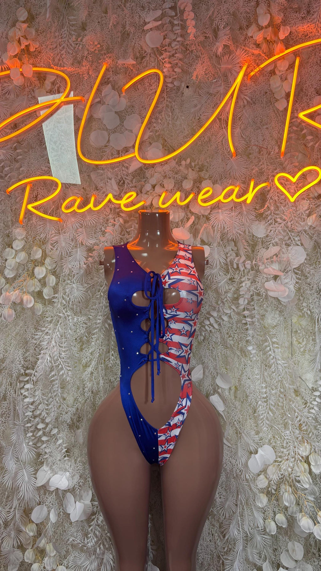 Patriotic blue bodysuit with star-and-stripe print; lace-up chest and sheer sleeves