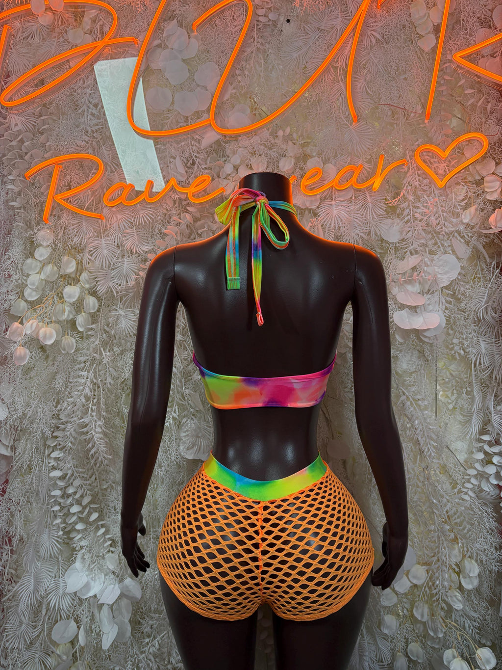 Orange festival bodysuit with rainbow straps and orange fishnet high-cut shorts