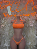 Orange strappy festival bikini set with halter top and low-rise bottoms