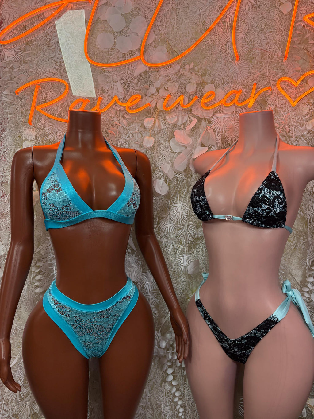Two-piece bikinis on mannequins: blue lace set and dark lace set, front view