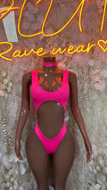 Pink rave bodysuit with halter neckline and central cutout, high-leg fit