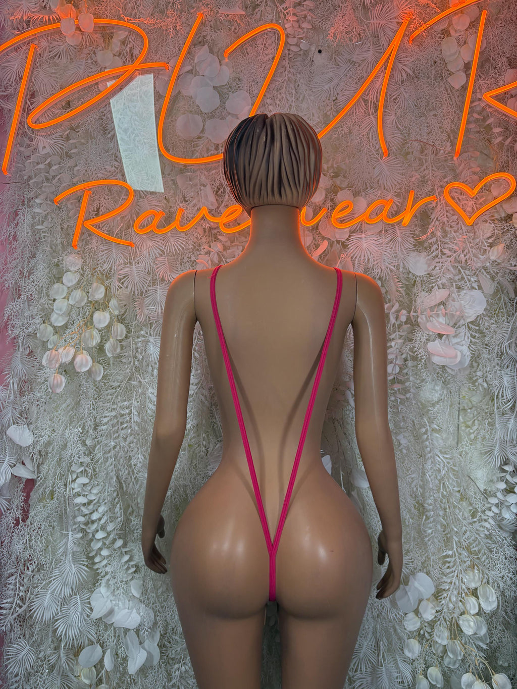 Hot pink one-piece bodysuit back view with crisscross straps and low open back