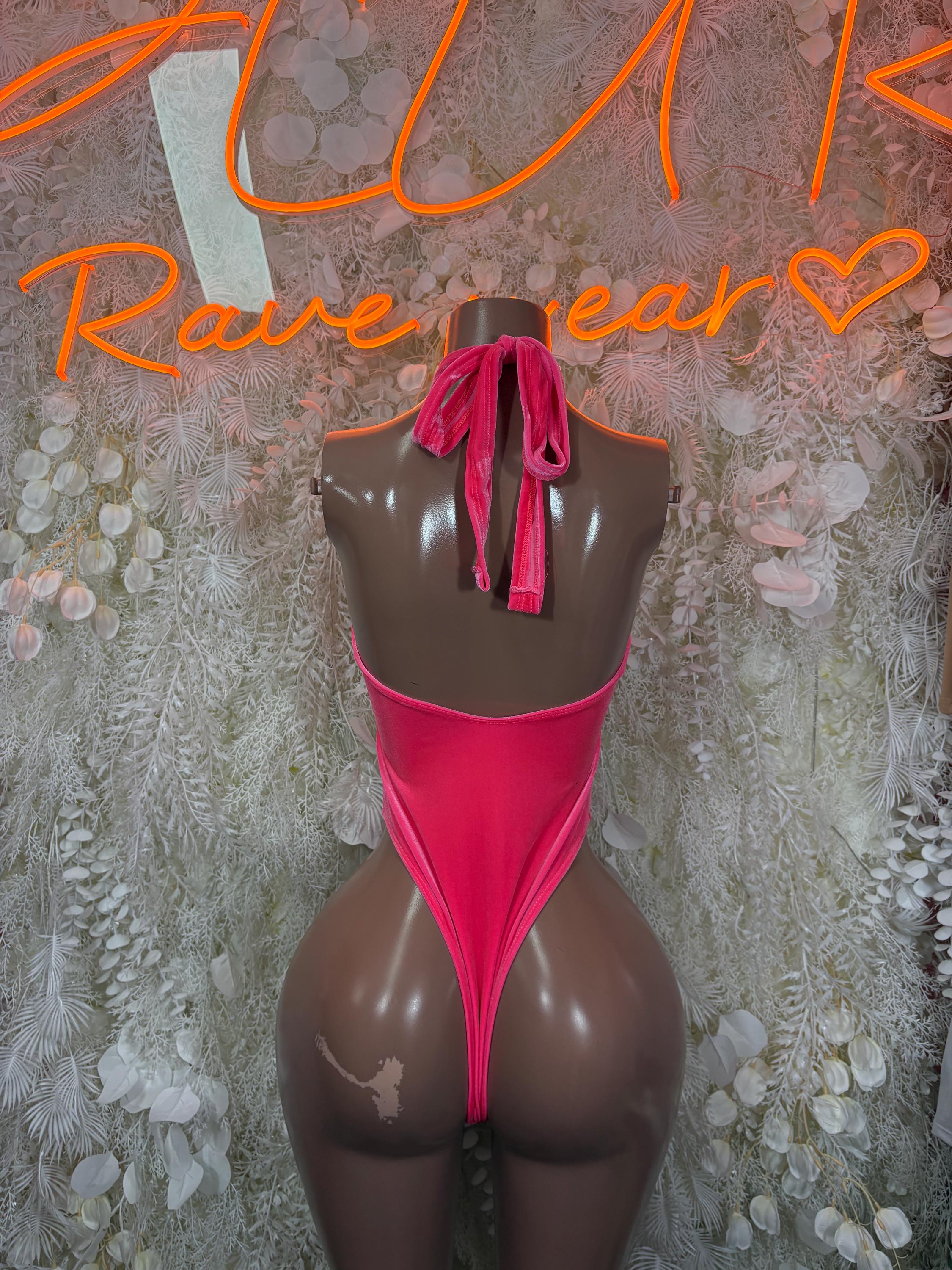 Pink halter bodysuit with back tie detail and high-cut coverage