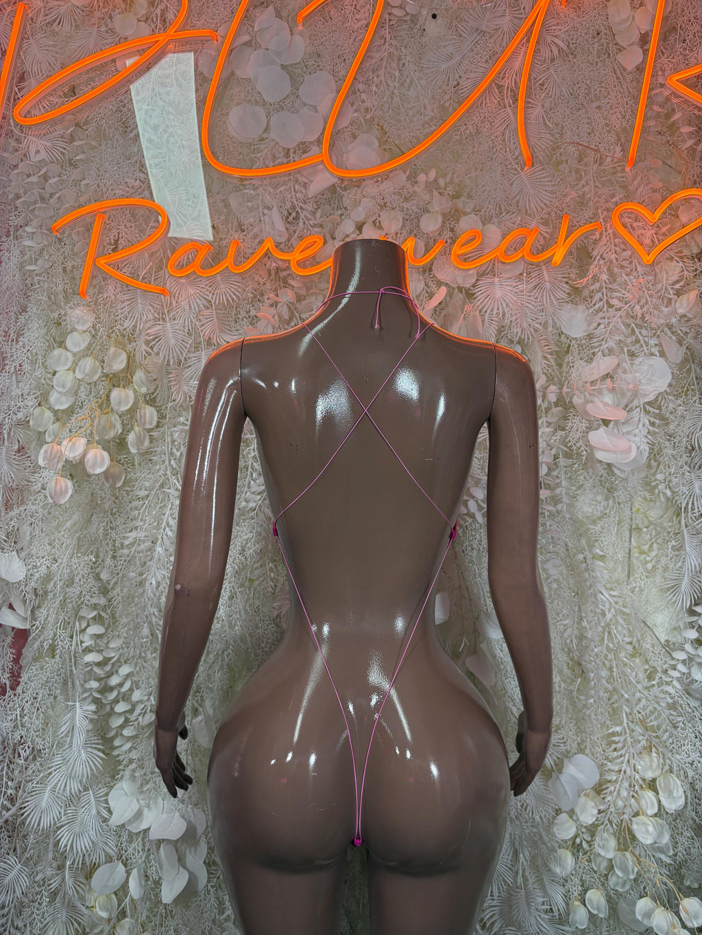 Pink rhinestone bodysuit with crisscross back and low neckline