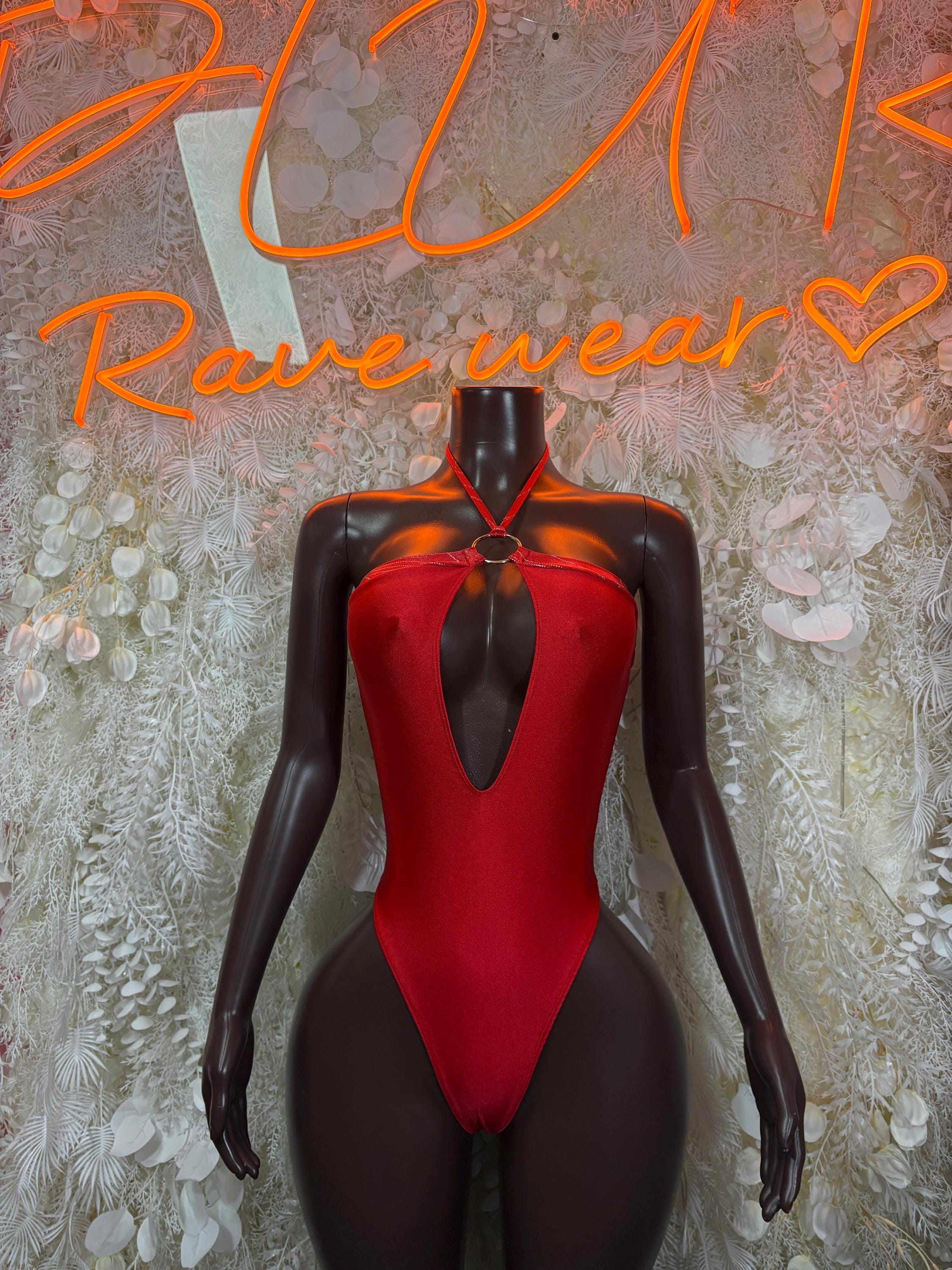 Red bodysuit with black sheer long sleeves, deep V neckline and center cutout