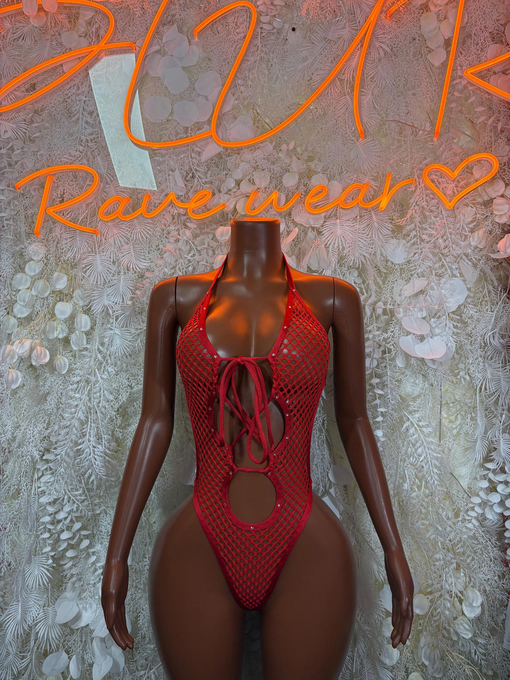 Red fishnet lace-up bodysuit with plunging neckline and circular waist cutout