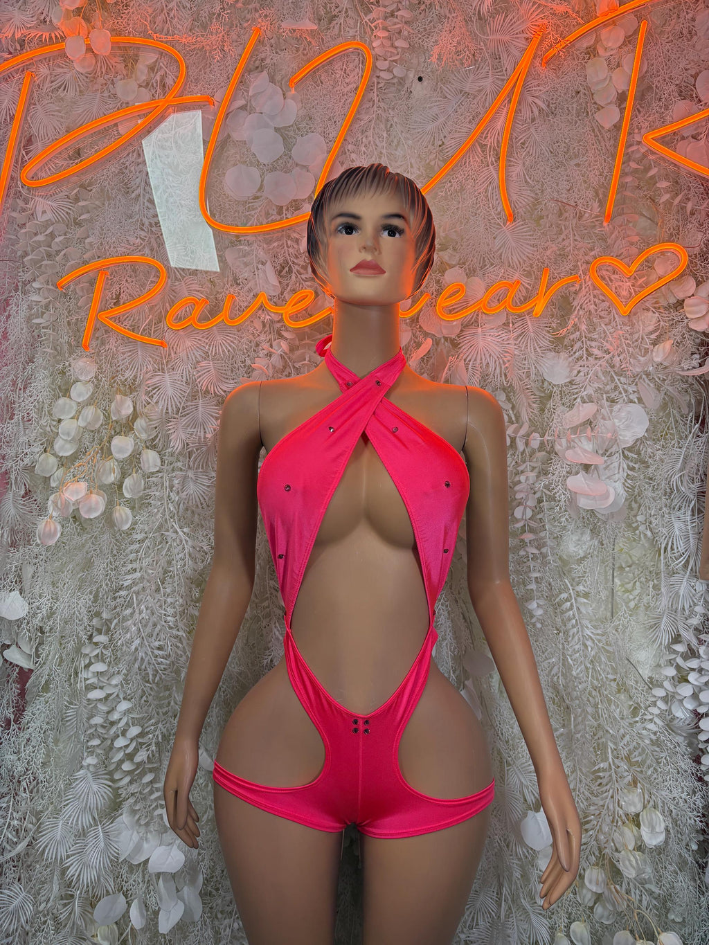 Pink halter bodysuit with halter tie and deep cutout front, thong-style bottom