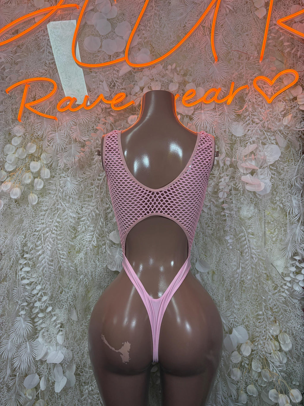 Pink fishnet one-piece bodysuit with wide cutouts at chest and sides