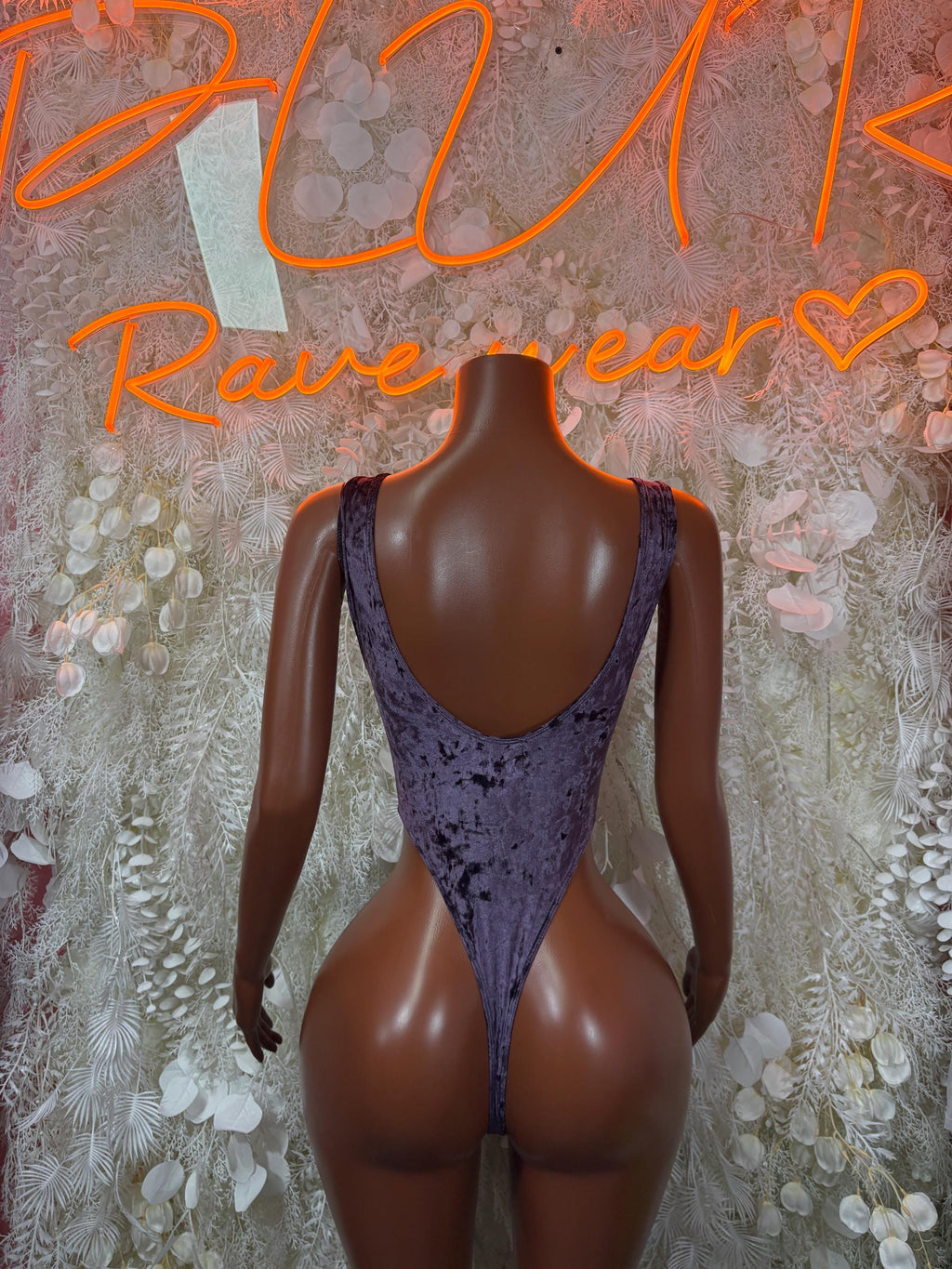 Purple velvet one-piece bodysuit with open back and scoop back neckline