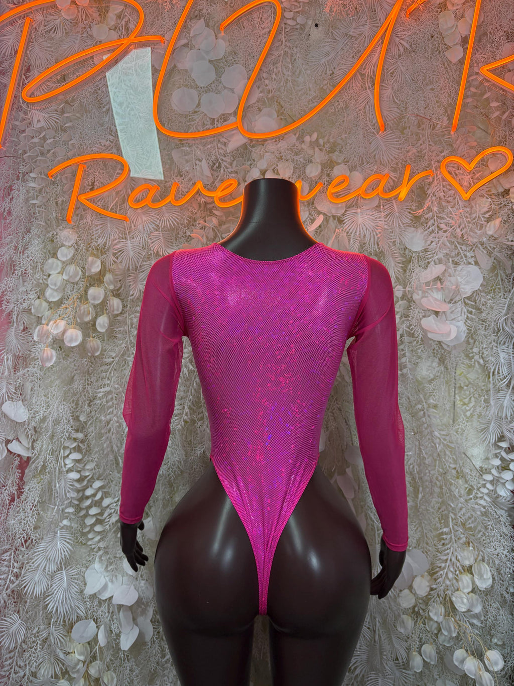 Pink long-sleeve glitter bodysuit with tie front and deep V neckline