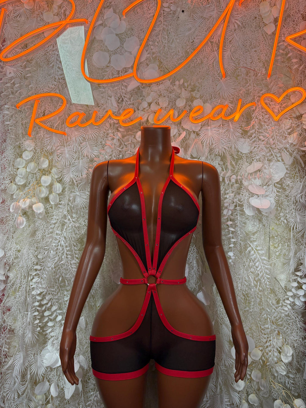 Red-and-black harness bodysuit with plunging neckline and halter straps