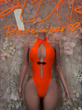 Neon orange halter one-piece bodysuit with chest keyhole cutout and black bow detail