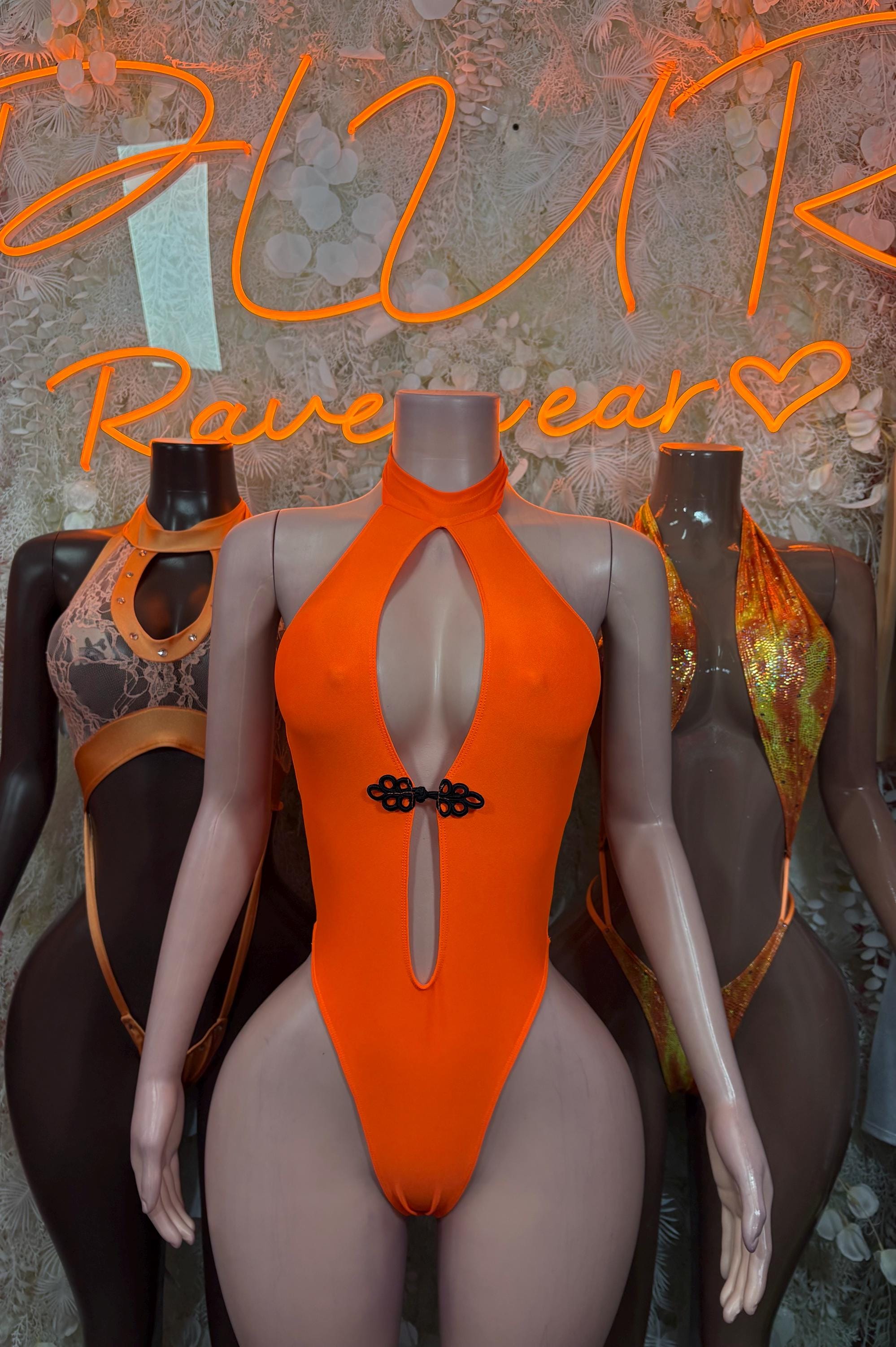 Orange halter one-piece bodysuit with lace yoke and central keyhole cutout