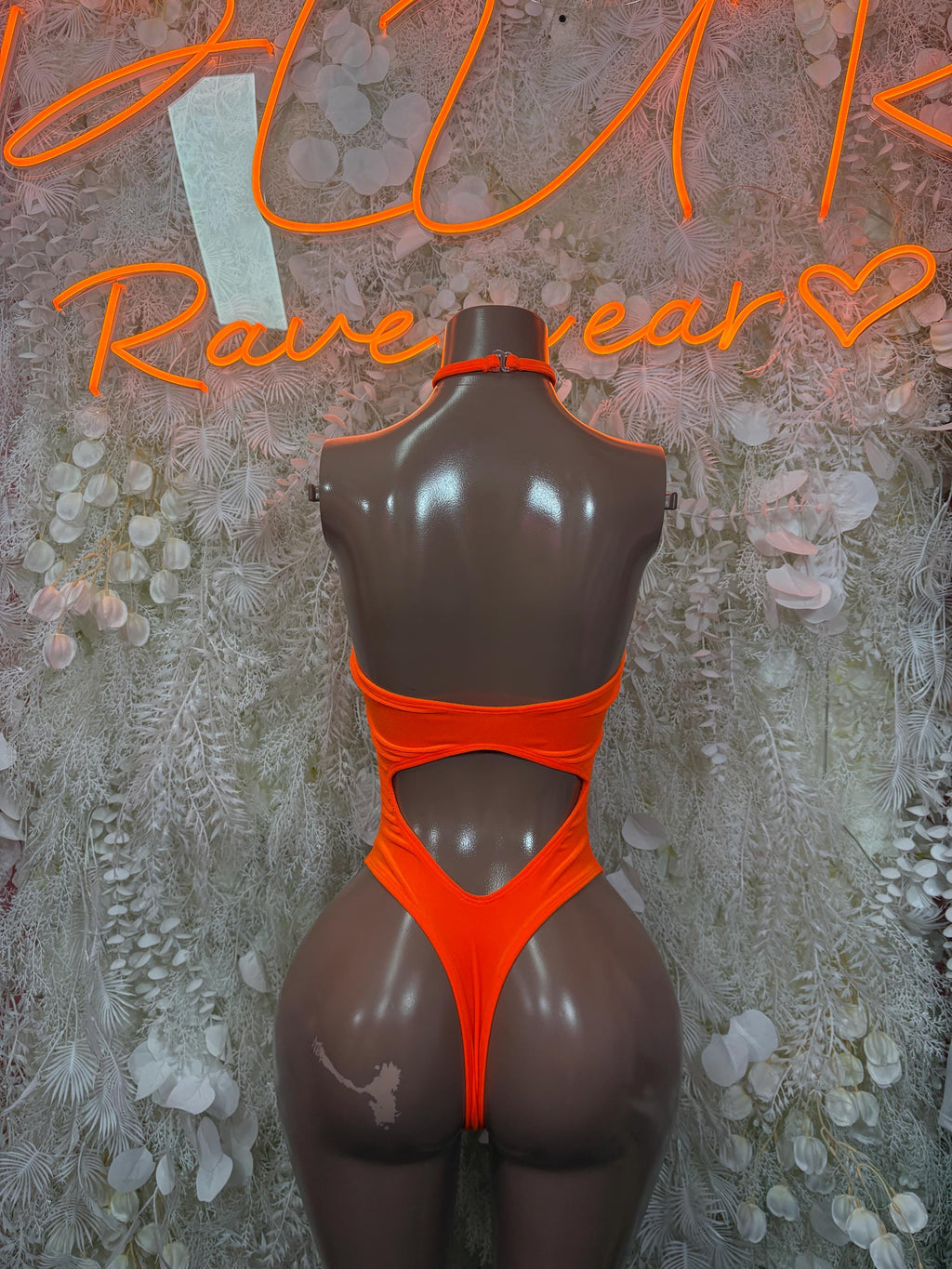 Orange one-piece bodysuit with high-cut legs and racerback straps