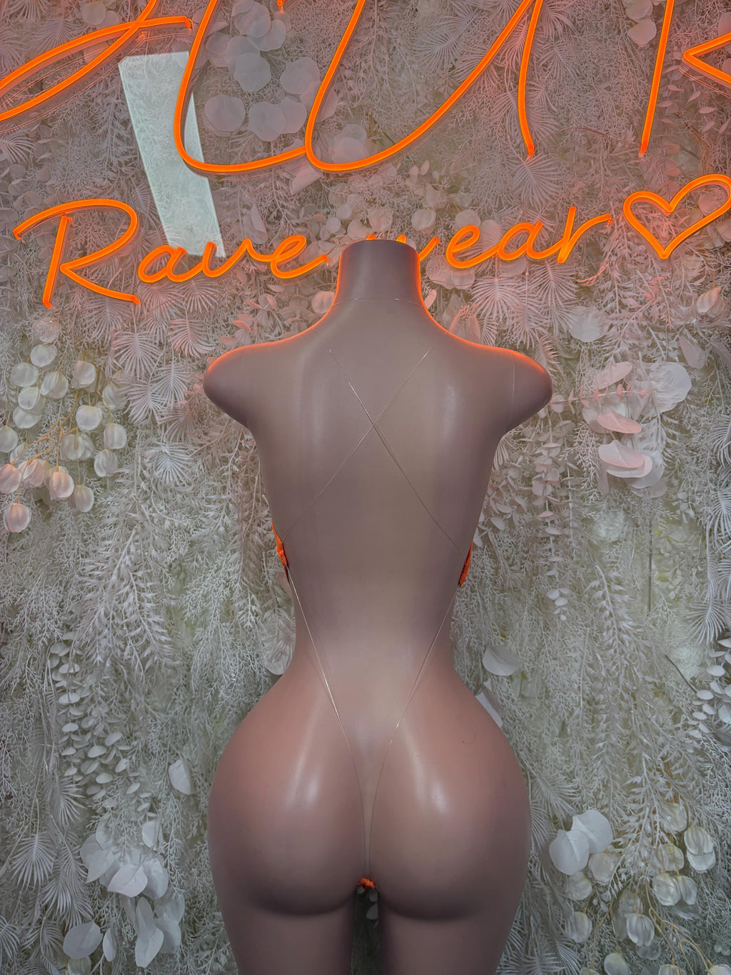 Orange mesh one-piece bodysuit with open back and low cut leg