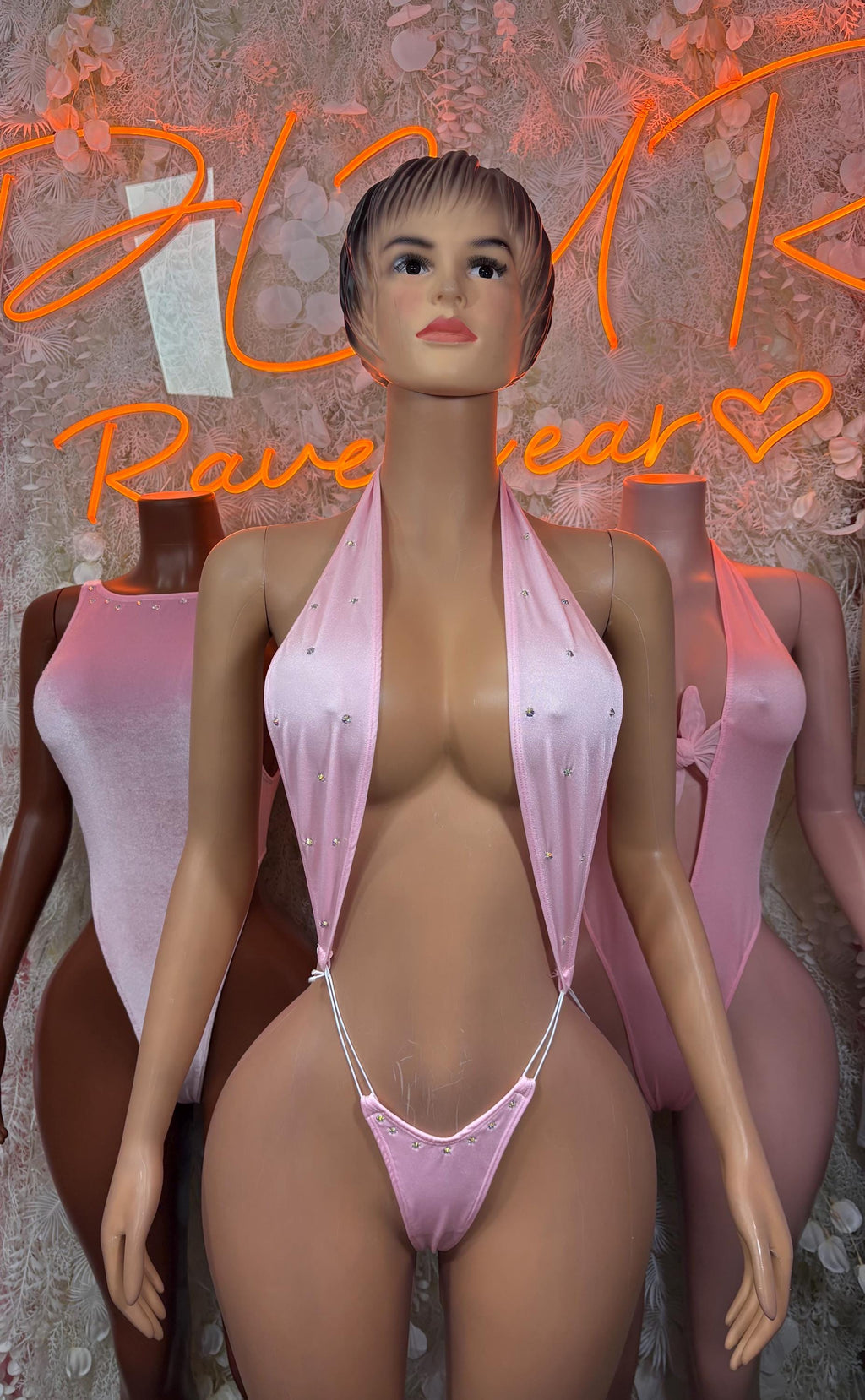 Pink halter one-piece bodysuit with V-front and matching side ties