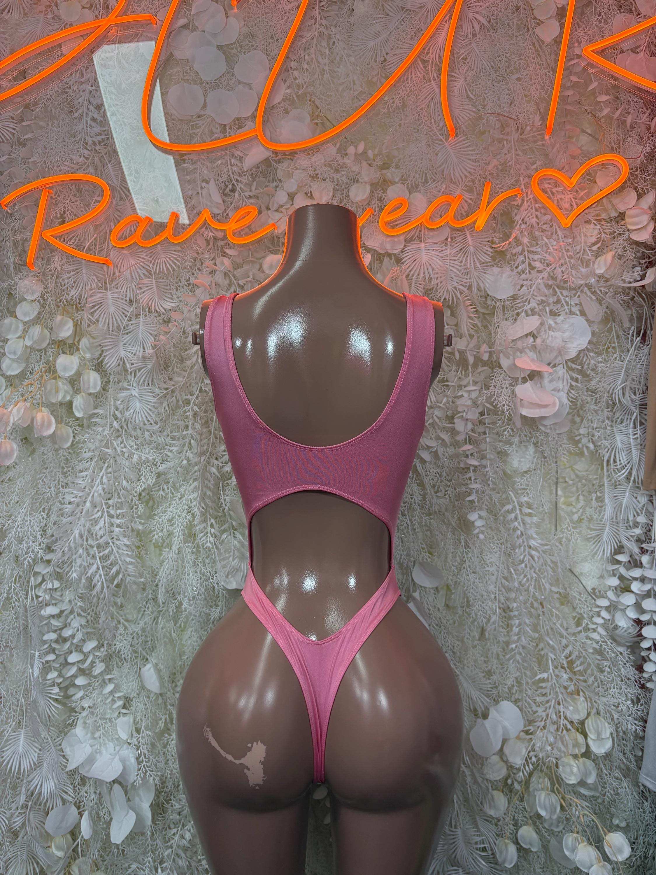 Pink one-piece bodysuit on mannequin with scoop neckline and high-cut leg openings.