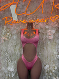 Pink one-piece bodysuit with scoop neckline and high-cut leg openings.