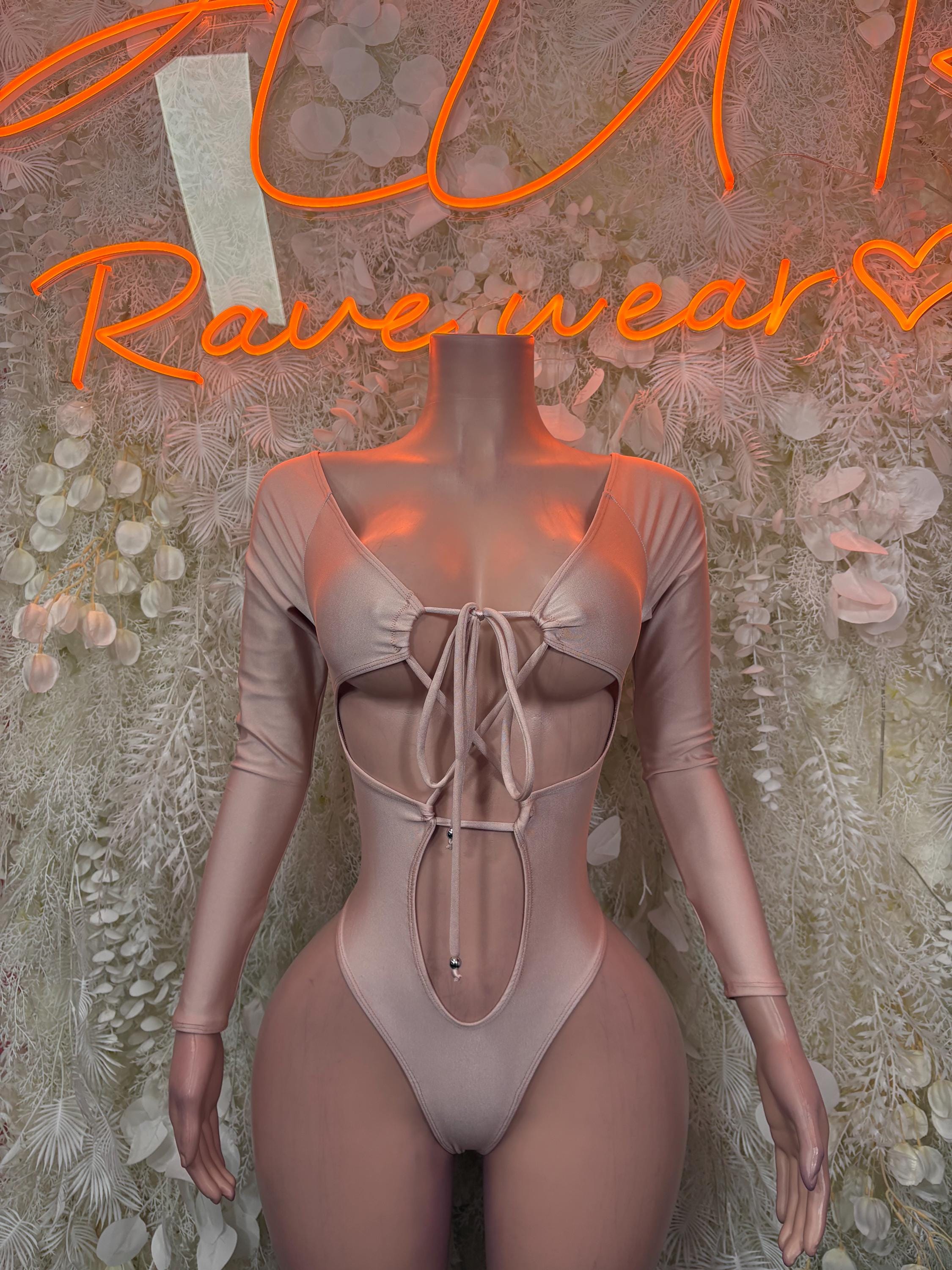 Nude one-piece bodysuit with long sleeves and lace-up front
