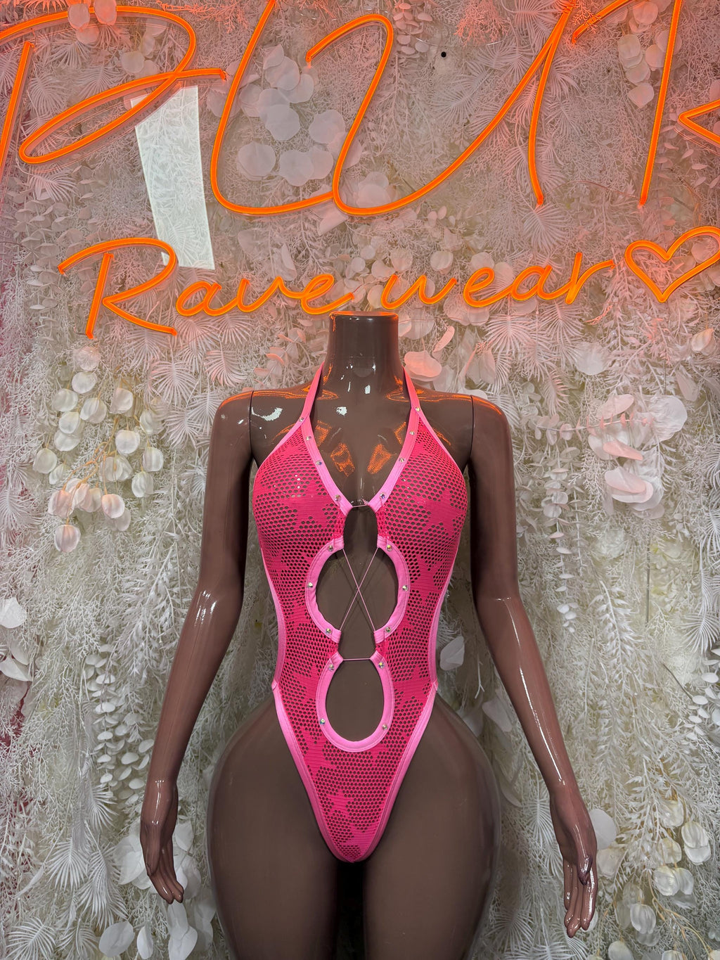Pink halter one-piece bodysuit with circular cutout detail at center