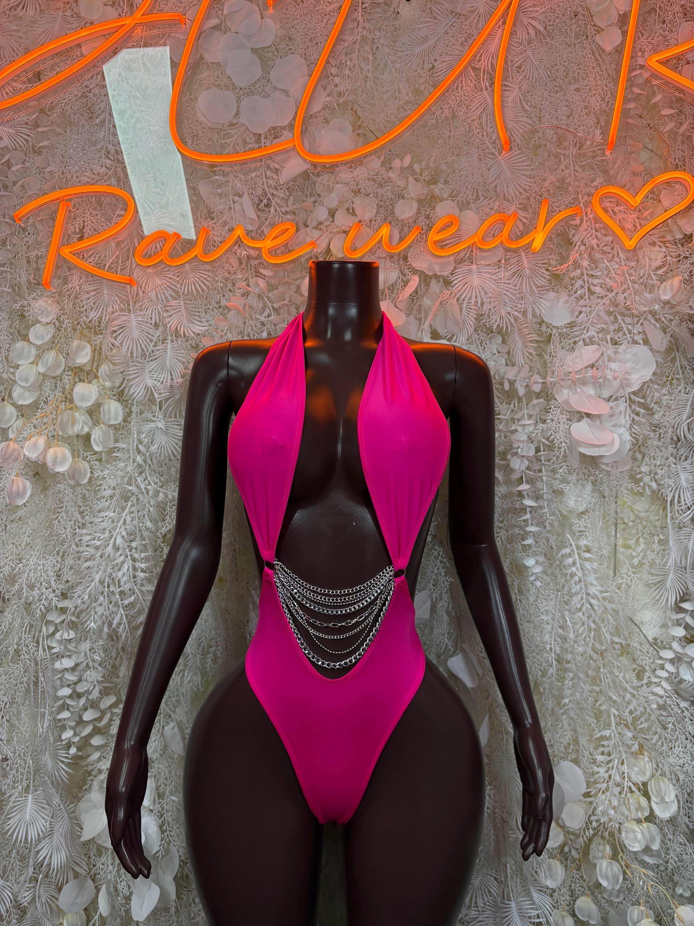 Pink one-piece bodysuit with deep V neckline and chain drape at chest
